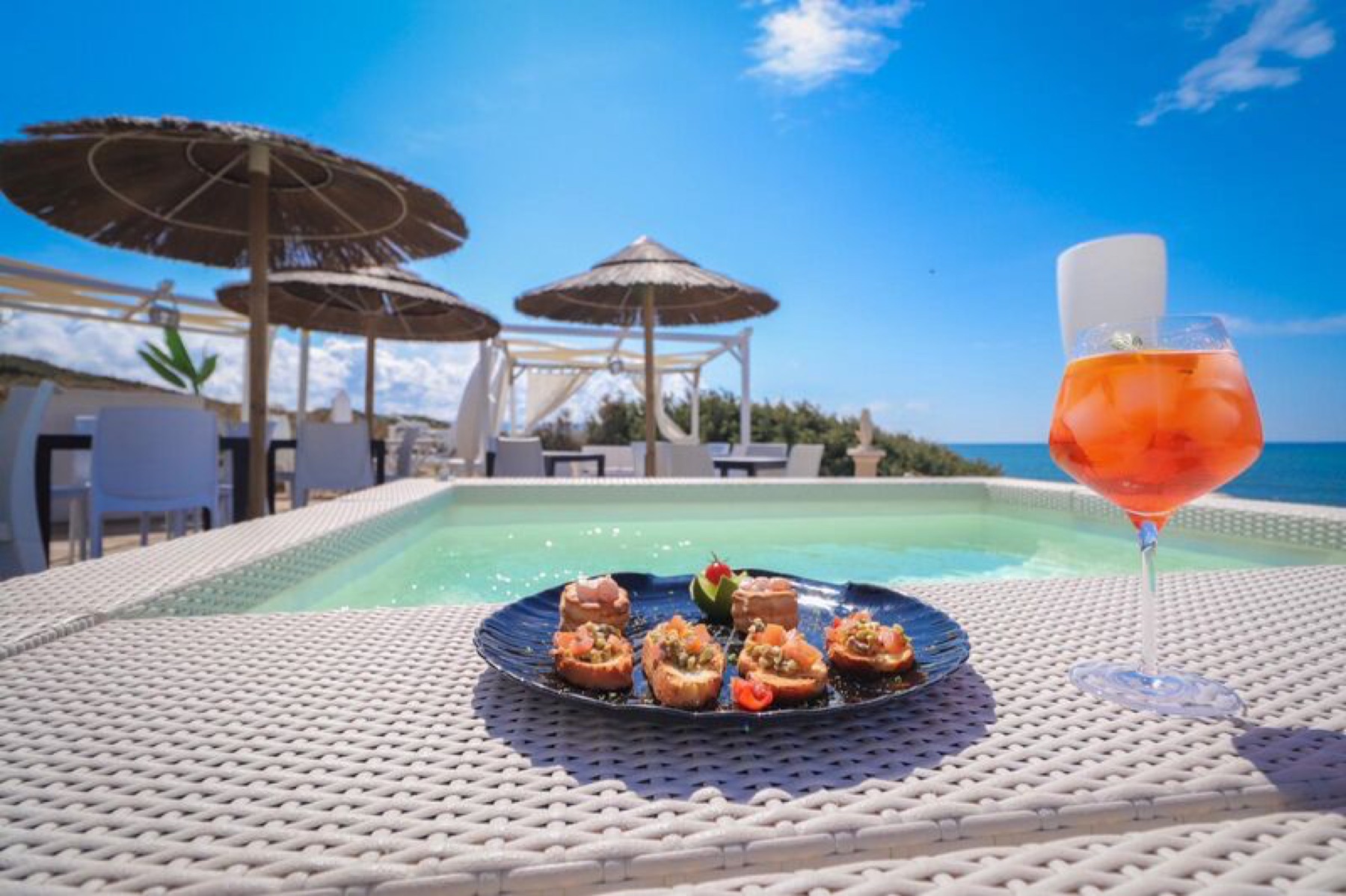 Aperitivo spritz and crostini at Calypso Beach Club, the sea behind